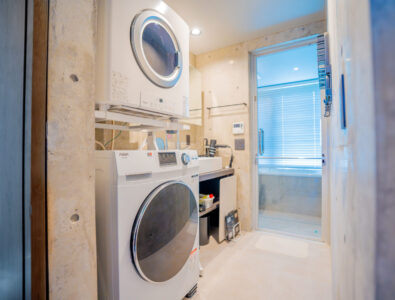 Modern laundry area with washing machine and dryer at Bayside Villa Miyako Iland.