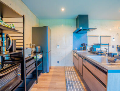 Spacious modern kitchen with cooking appliances and open shelving at Bayside Villa Miyako Iland.