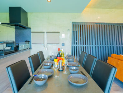 Elegant dining table set with dishes, glasses, and wine at Bayside Villa Miyako Iland.