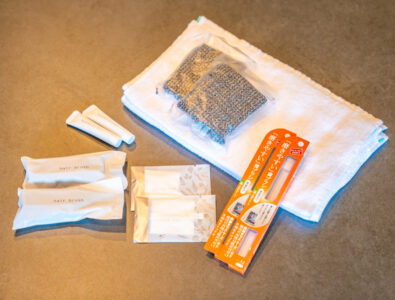 Amenities set with towels, toothbrushes, hairbrushes, and bath essentials at Bayside Villa Miyakojima.