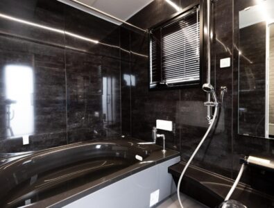 Luxury bathroom with black bathtub and rainfall shower at Ocean Villa Naruto, designed for a relaxing experience.
