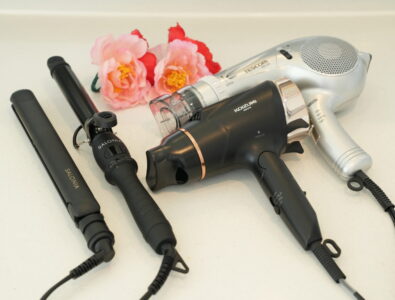 Hair styling set with hairdryer, straightener, and curling iron, featuring floral accents at Ocean Villa Tokunoshima.