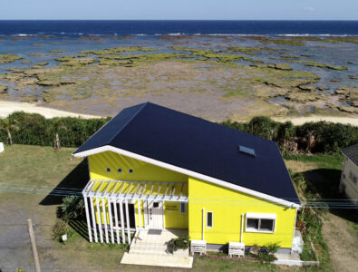 Yellow villa near the beach with a modern design and lush surroundings at Ocean Villa Tokunoshima.