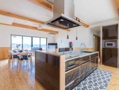 Spacious kitchen and dining area with ocean view at Ocean Villa Naruto, featuring modern amenities and stylish wooden interior.
